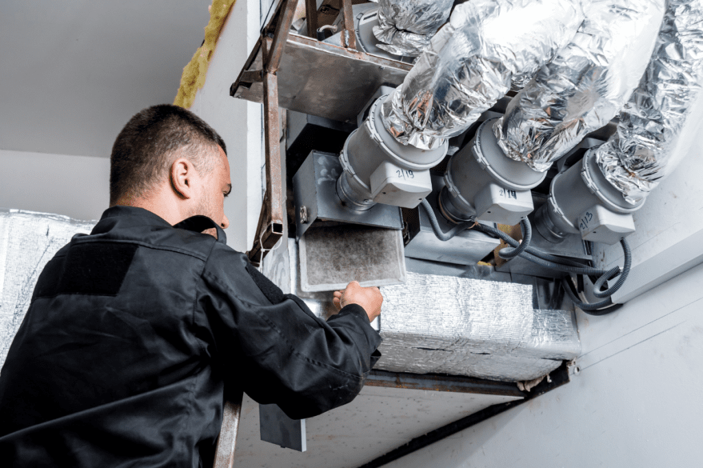 What is HVAC – An HVAC technician checking the filters.