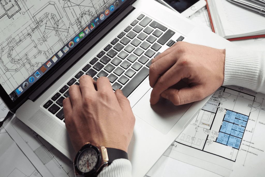 Hand on a laptop displaying a property blueprint