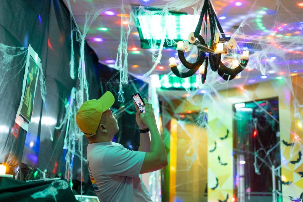 A man taking a photo of Halloween Decoration